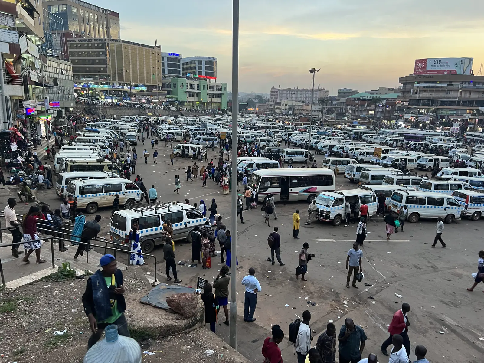 Hundreds of white minibus taxis parked in a Kampala taxi park, Uganda
